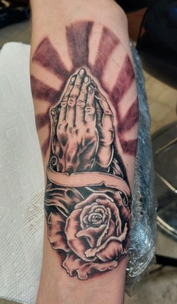 praying hands and a flower