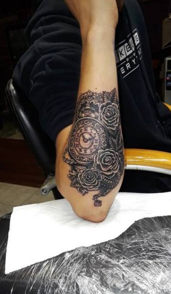 black clock and flowers tattoo