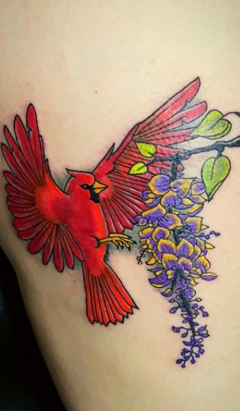 red bird approching to a flower