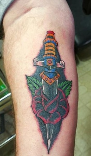 dagger pierced in a red rose